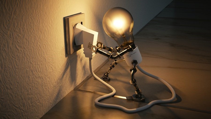 A light bulb plugging into an electrical outlet, representing the importance of UX testing to illuminate the user experience.