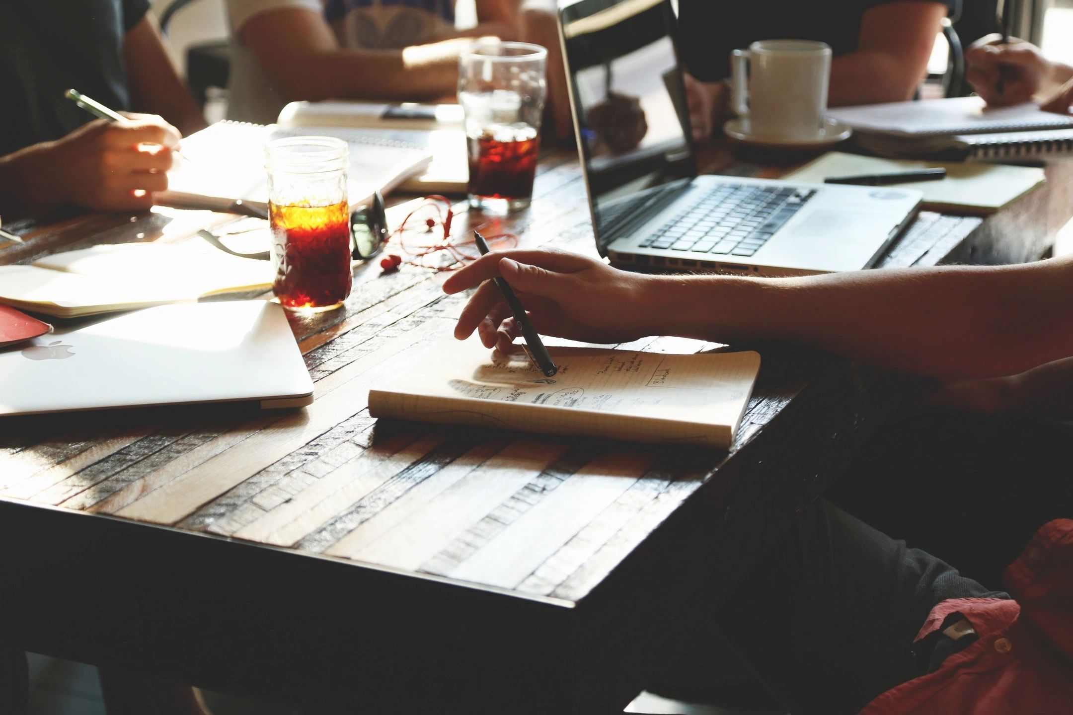 Team collaborating in a coworking space, representing the improvement in productivity and collaboration with Checkealos